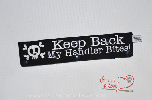 One Leash Sleeve embroidered with the following on both sides of the sleeve:       Keep Back My Handler Bites, skull with cross bones      Example in the listing photo has the following color selections:        • black fabric, white (1805) text.