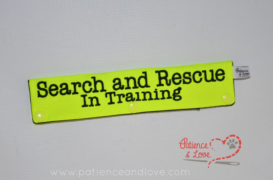 One Leash Sleeve embroidered with the following on both sides of the sleeve:        Search and Rescue        In Training      Example in the listing photo has the following color selections:        • Bright yellow fabric, black (1800) text.