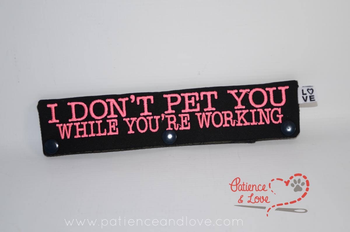 One Leash Sleeve embroidered with the following on both sides of the sleeve:       I Don't Pet You While You're Working      Example in the listing photo has the following color selections:        • black fabric, pink (1909) text.