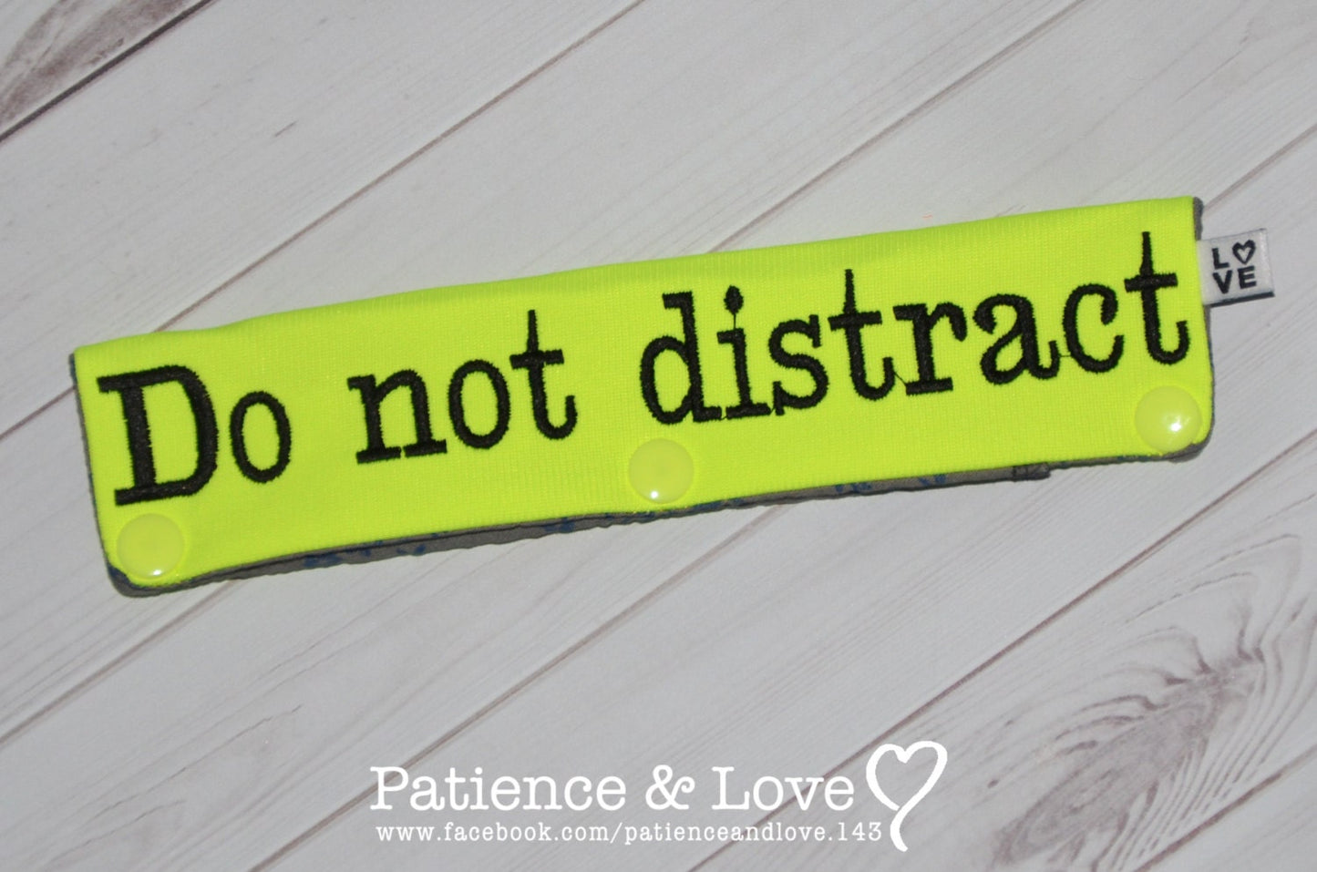 Bright yellow sleeve with black text that says do not distract