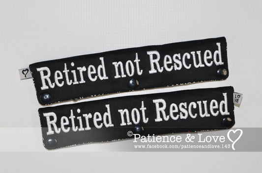 One Leash Sleeve embroidered with the following on both sides of the sleeve        Retired not Rescued  As seen in the listing photo.   Listing photo shows black fabric with white text.