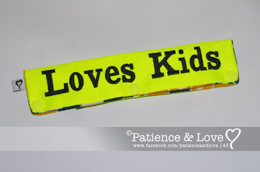 One Leash Sleeve embroidered with the following on both sides of the sleeve:       Loves Kids      Example in the listing photo has the following color selections:        • Bright yellow fabric, Black (1800) text.