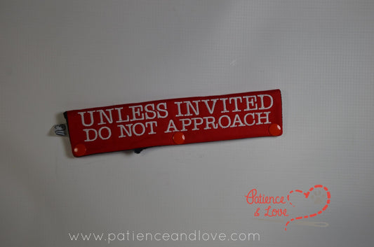 One Leash Sleeve embroidered with the following on both sides of the sleeve:        UNLESS INVITED        DO NOT APPROACH     Example in the listing photo has the following color selections:        • Red fabric, White (1805) text.