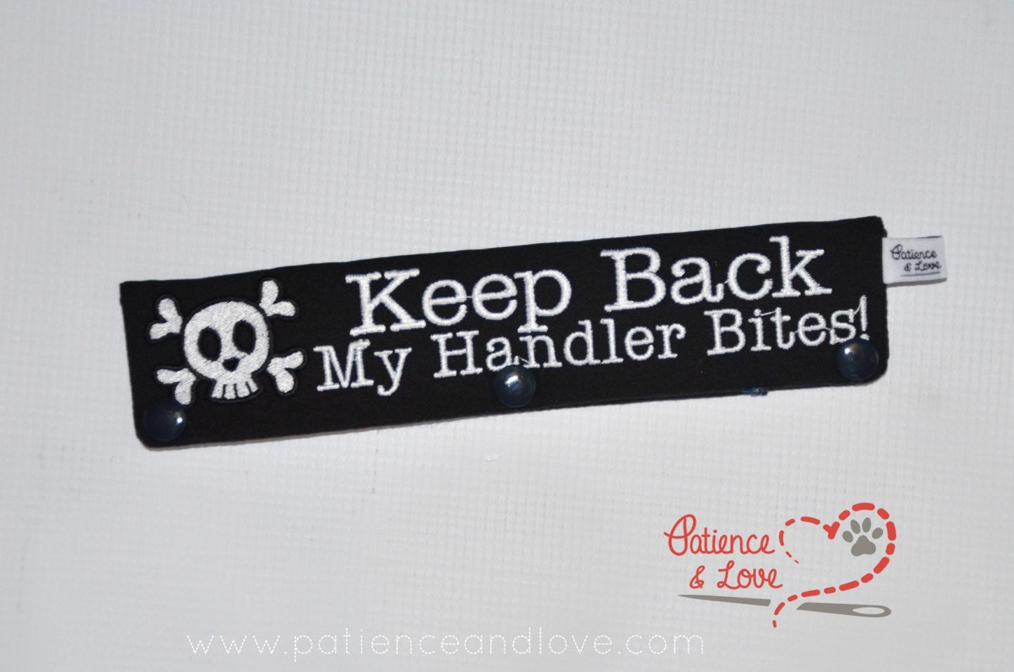One Leash Sleeve embroidered with the following on both sides of the sleeve:       Keep Back My Handler Bites, skull with cross bones      Example in the listing photo has the following color selections:        • black fabric, white (1805) text.
