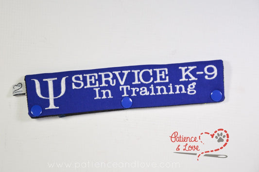 One Leash Sleeve embroidered with the following on both sides of the sleeve:      SERVICE K-9 In Training with the Psi symbol infront of the text     Example in the listing photo has the following color selections:        • Blue fabric, White (1805) text.