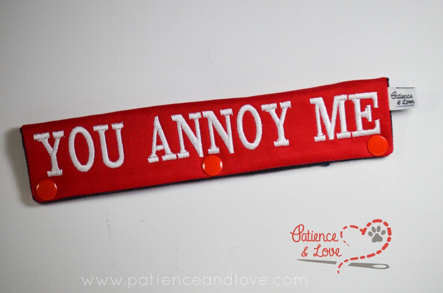 One Leash Sleeve embroidered with the following on both sides of the sleeve:       Go Away - You Annoy Me      Example in the listing photo has the following color selections:        • Red fabric, White (1805) text.