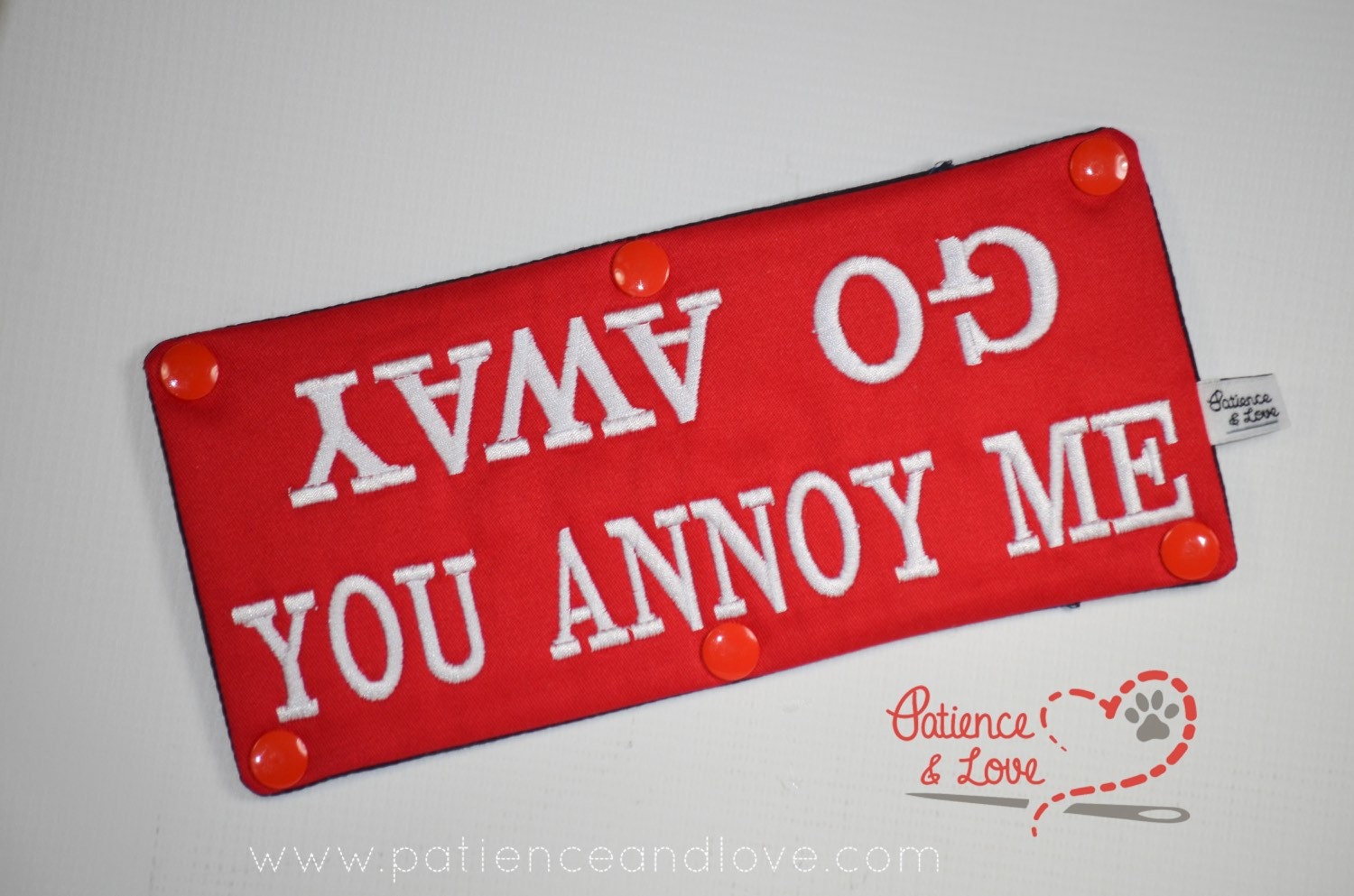 One Leash Sleeve embroidered with the following on both sides of the sleeve:       Go Away - You Annoy Me      Example in the listing photo has the following color selections:        • Red fabric, White (1805) text.