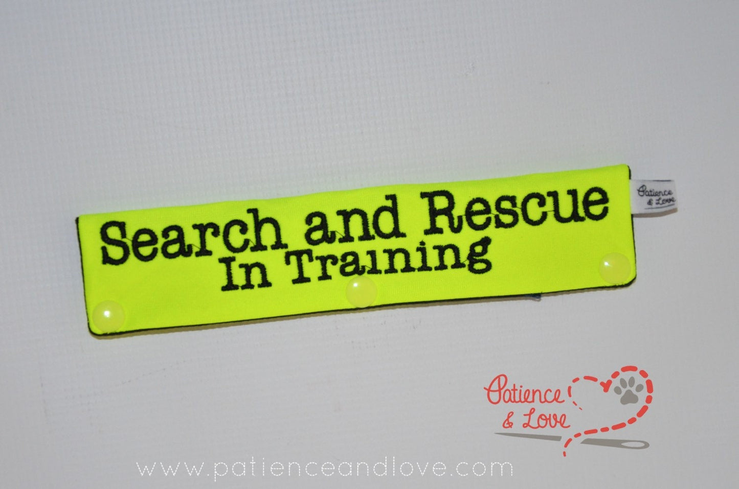 One Leash Sleeve embroidered with the following on both sides of the sleeve:        Search and Rescue        In Training      Example in the listing photo has the following color selections:        • Bright yellow fabric, black (1800) text.